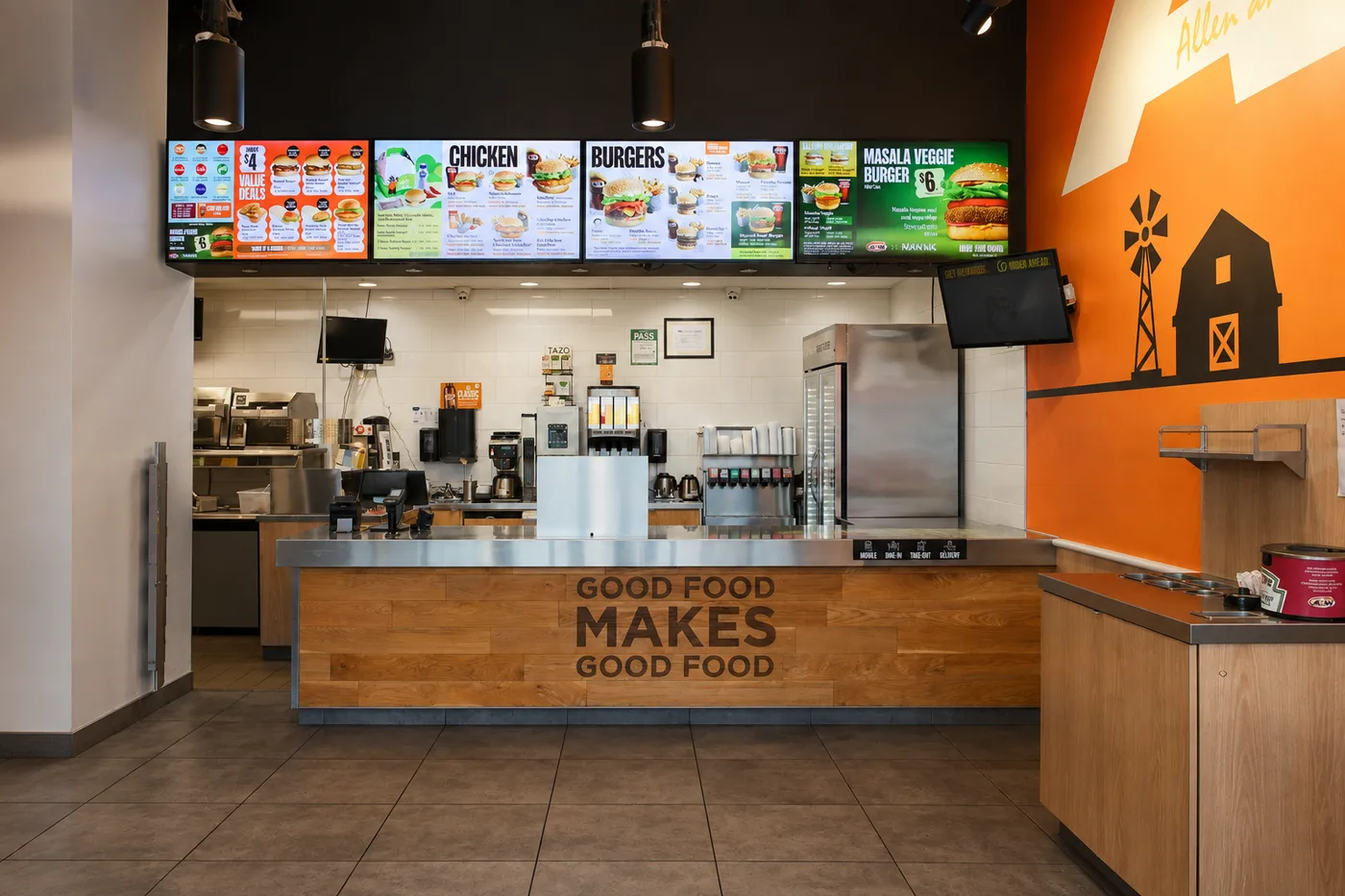 Horizontal digital menu boards above a restaurant counter showing categorized menu panels